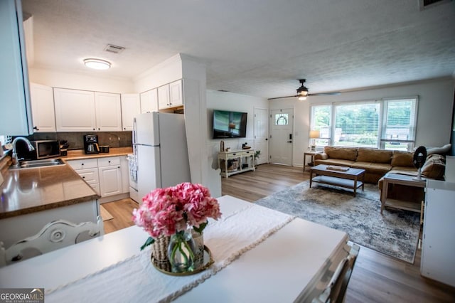 4529 Lakeview Dr, Powder Springs, GA 30127 - dining room featuring a ceiling fan and light wood-type flooring