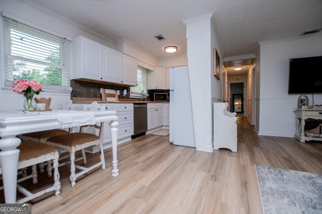4529 Lakeview Dr, Powder Springs, GA 30127 - kitchen with dishwasher, white cabinetry, freestanding refrigerator, light wood-style floors, and ornamental molding