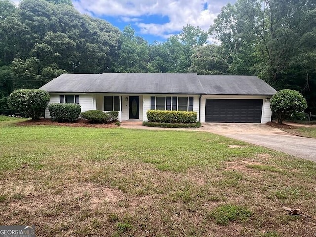 single story home with a garage, a front lawn, and concrete driveway