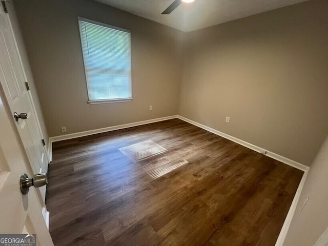 unfurnished room with ceiling fan, baseboards, and dark wood-style flooring