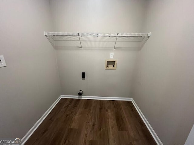 clothes washing area with electric dryer hookup, washer hookup, wood finished floors, and baseboards
