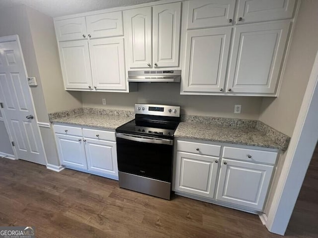 kitchen with electric range, under cabinet range hood, dark wood-style flooring, and white cabinetry
