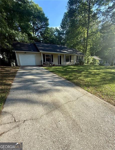 2661 Throatlatch Ln, Marietta, GA 30064 - ranch-style house with asphalt driveway, a garage, covered porch, and a front lawn