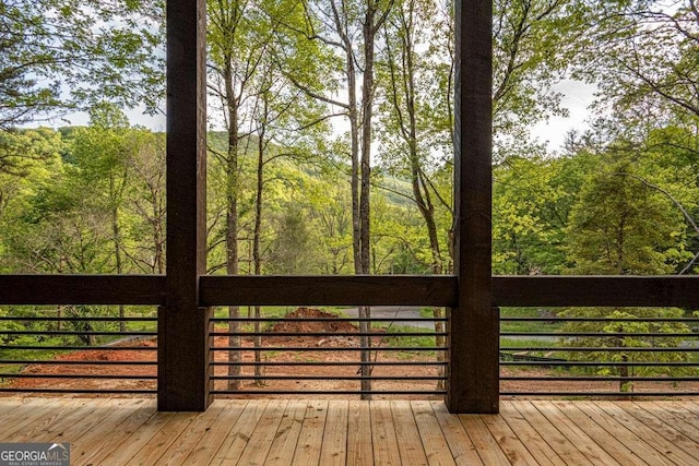 wooden terrace with a wooded view