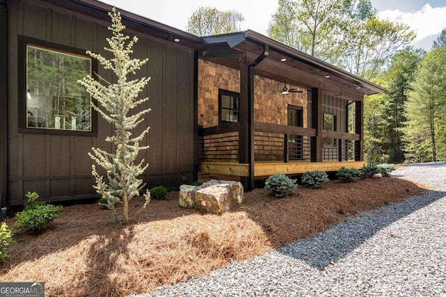 view of property exterior with a porch and stone siding