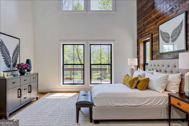 bedroom featuring a high ceiling and multiple windows