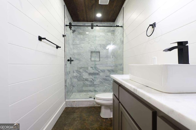 bathroom featuring a stall shower, toilet, and vanity