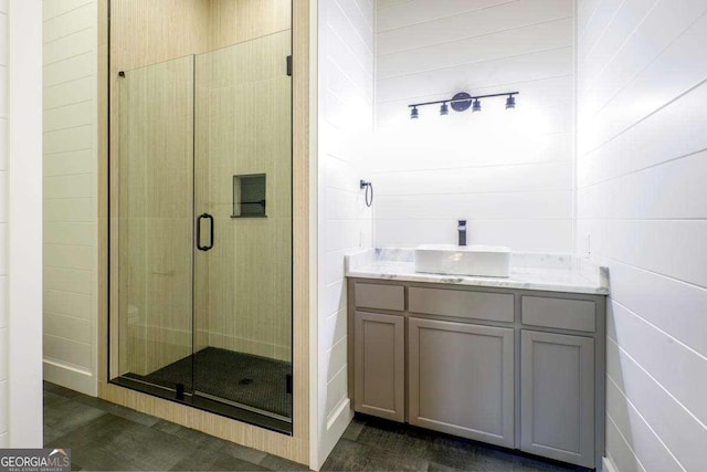 bathroom with a shower stall and vanity