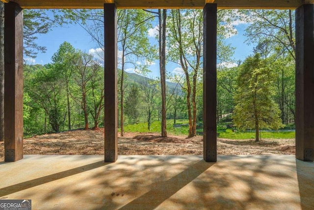 view of patio with a forest view and a mountain view