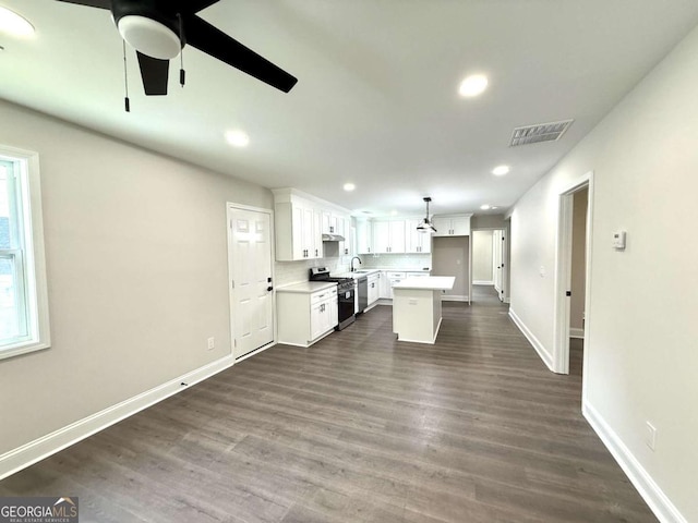 6205 Hudson St NW, Covington, GA 30014 - kitchen featuring stainless steel gas stove, a ceiling fan, light countertops, white cabinetry, and recessed lighting