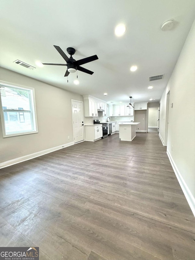 6205 Hudson St NW, Covington, GA 30014 - unfurnished living room featuring baseboards, recessed lighting, and ceiling fan