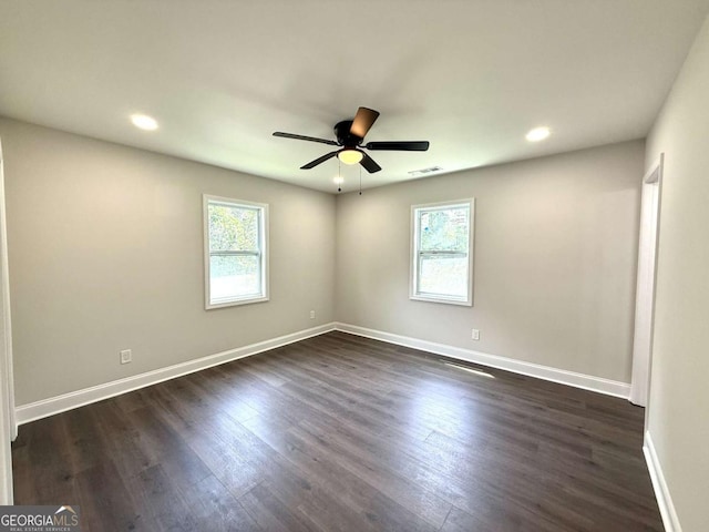 empty room with plenty of natural light, ceiling fan, dark wood-style flooring, and recessed lighting
