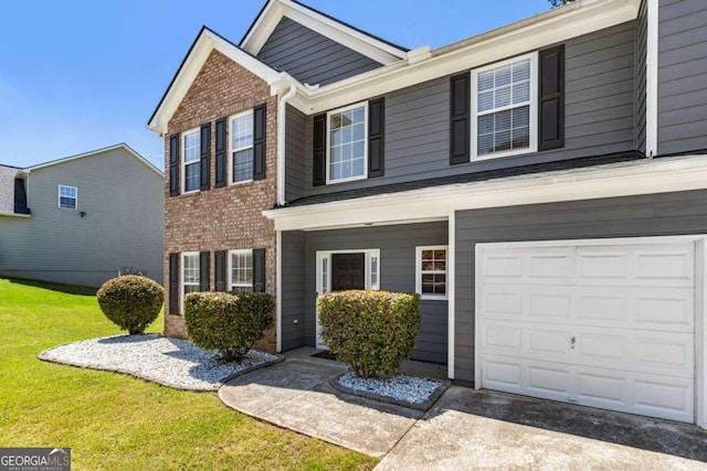 view of front facade with brick siding, a front lawn, a garage, and driveway