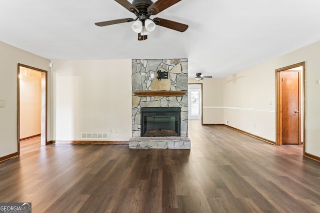 368 Henry Higgins Rd, Jackson, GA 30233 - unfurnished living room with ceiling fan, wood finished floors, and a stone fireplace