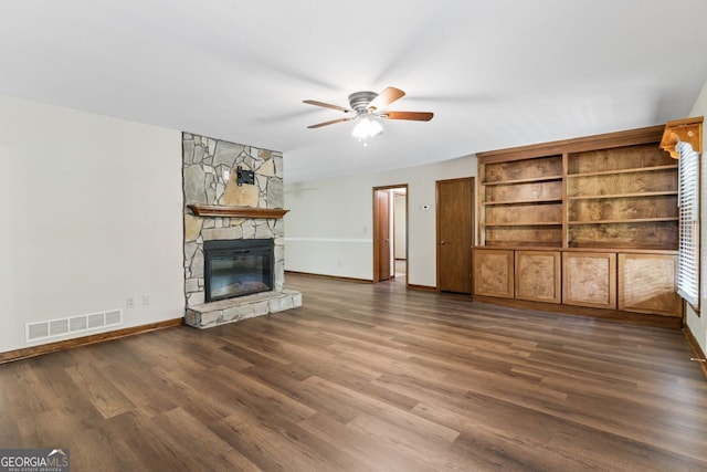 368 Henry Higgins Rd, Jackson, GA 30233 - unfurnished living room featuring ceiling fan, baseboards, a fireplace, and dark wood-style floors