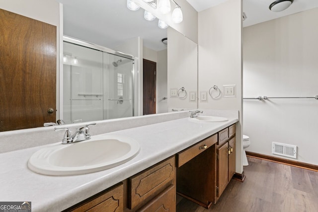 368 Henry Higgins Rd, Jackson, GA 30233 - bathroom with a stall shower, toilet, wood finished floors, double vanity, and baseboards