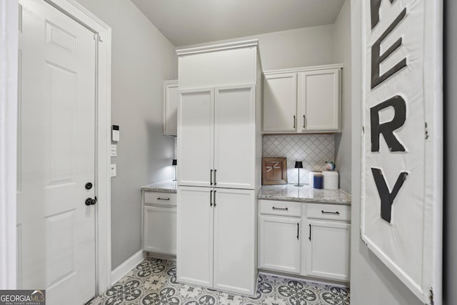 laundry area featuring baseboards