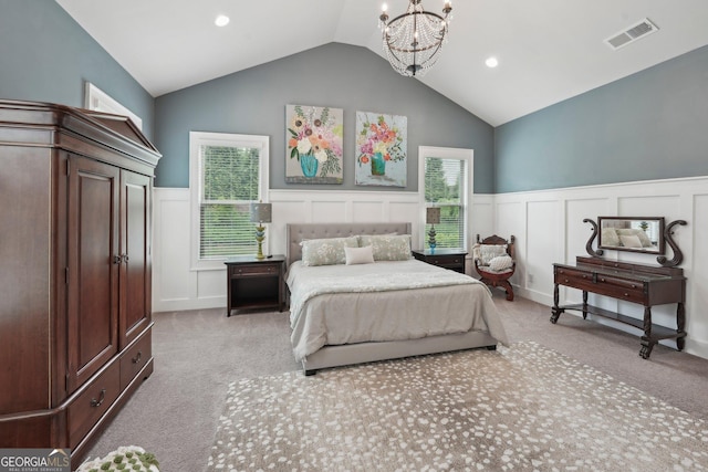 bedroom with carpet, a decorative wall, a chandelier, wainscoting, and vaulted ceiling