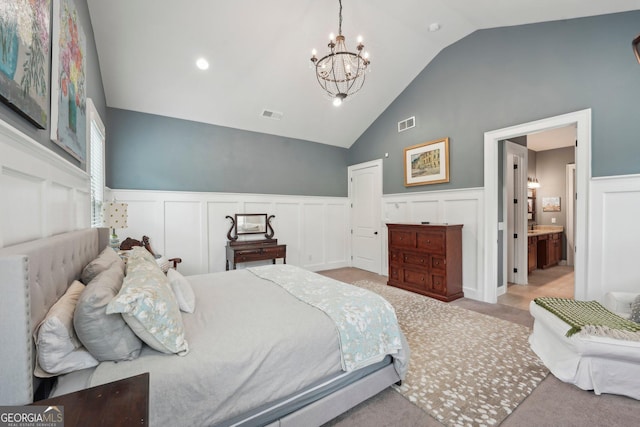 bedroom with vaulted ceiling, wainscoting, a chandelier, a decorative wall, and carpet