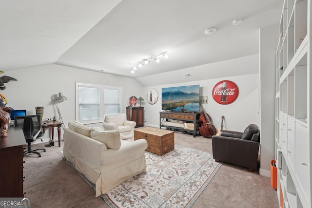 carpeted living room with vaulted ceiling, an office area, track lighting, and baseboards