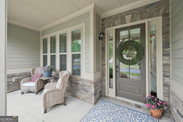 entrance to property with a porch and stone siding