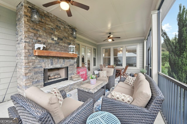 sunroom / solarium featuring a ceiling fan and an outdoor living space with a fireplace