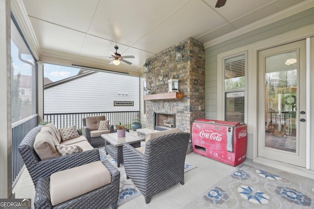 view of patio with a ceiling fan and an outdoor living space with a fireplace