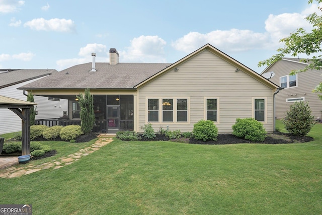 view of front of home featuring a gazebo, a front yard, and a chimney
