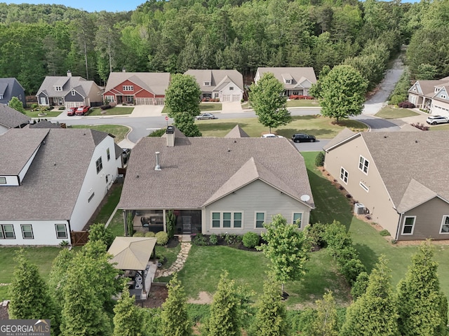 aerial view of residential area featuring a forest