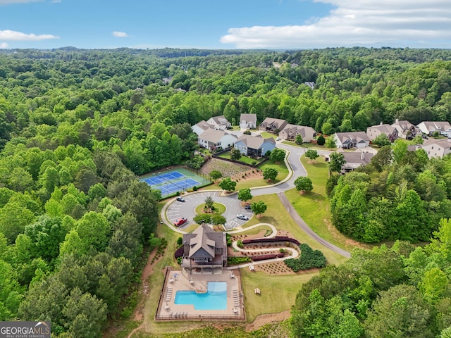 aerial view of a forest and a pool area