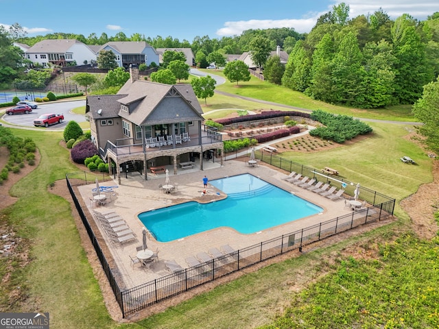 community pool featuring a wooden deck, a patio, and stairway
