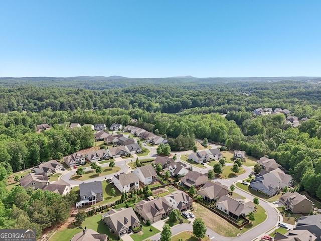 aerial view of residential area with a heavily wooded area