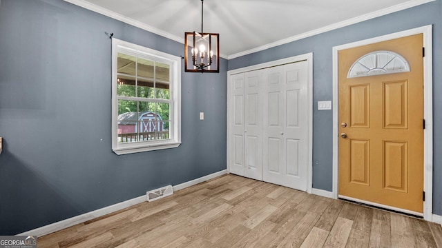 19 Fernwood Way NE, Rome, GA 30161 - entrance foyer featuring a chandelier, wood finished floors, baseboards, and crown molding