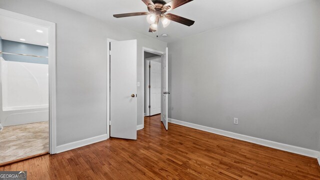 19 Fernwood Way NE, Rome, GA 30161 - unfurnished bedroom with baseboards, wood finished floors, and ceiling fan