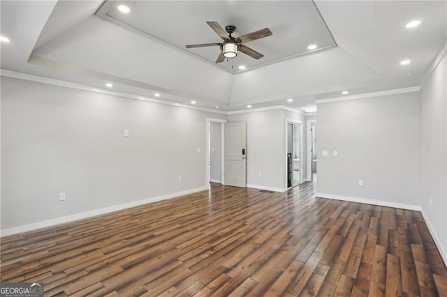 unfurnished living room with ceiling fan, a raised ceiling, recessed lighting, crown molding, and wood finished floors