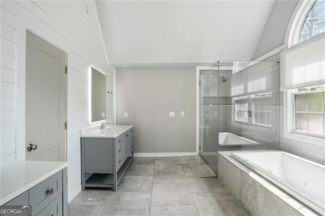 bathroom featuring tiled shower, vanity, tiled bath, and high vaulted ceiling