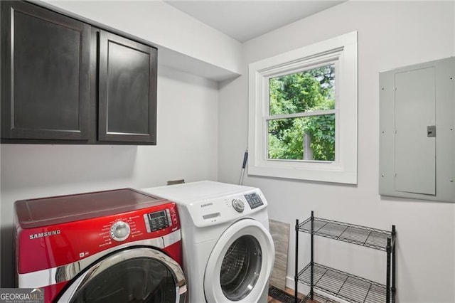 laundry area with washer and dryer, cabinet space, and electric panel