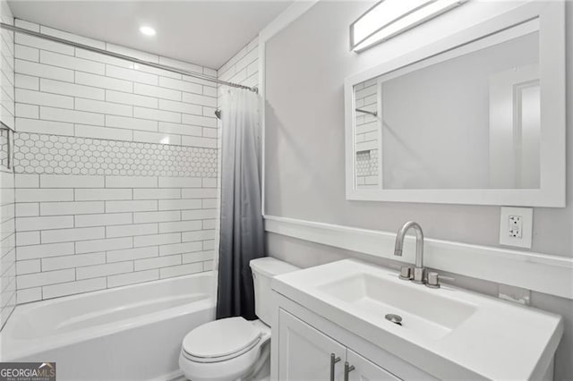 bathroom with toilet, shower / bath combo, and vanity