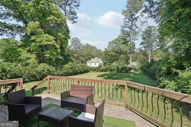 deck featuring a lawn and outdoor lounge area