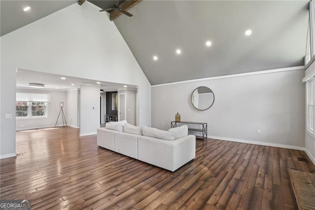 living room with a ceiling fan, high vaulted ceiling, baseboards, wood finished floors, and recessed lighting