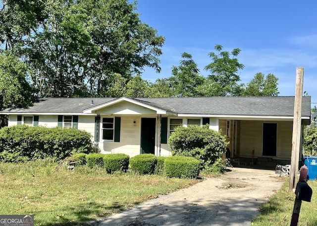 single story home with driveway and a carport