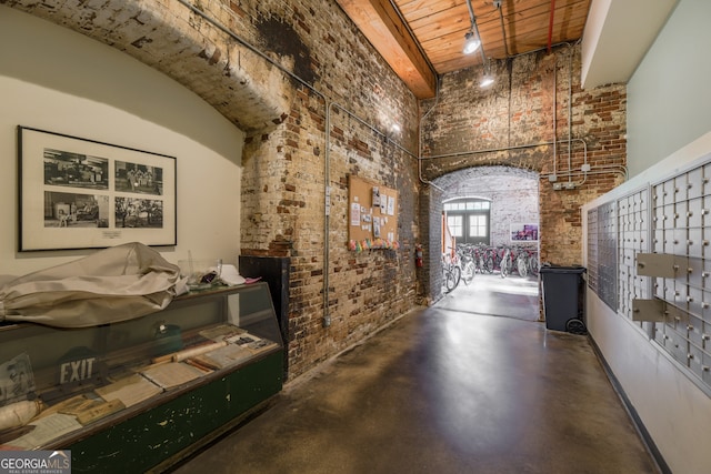 170 Boulevard Se 521H, Atlanta, GA 30312 - wine room featuring brick wall, a high ceiling, finished concrete floors, and mail area
