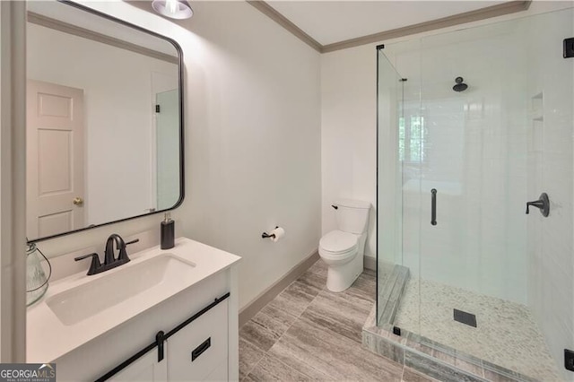 full bath with toilet, a stall shower, vanity, ornamental molding, and baseboards