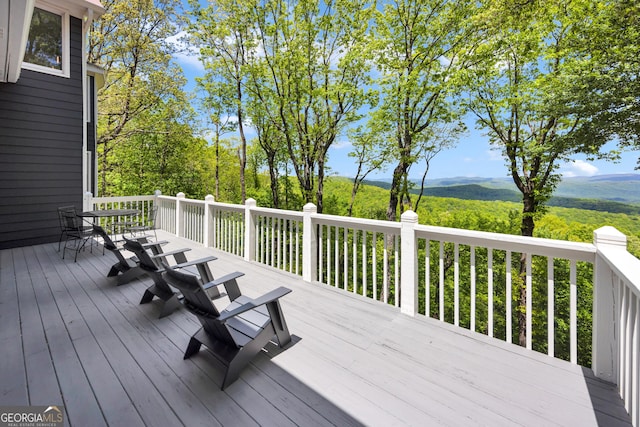 wooden terrace with outdoor dining space
