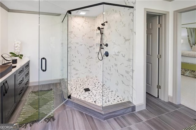 bathroom with a shower stall and baseboards