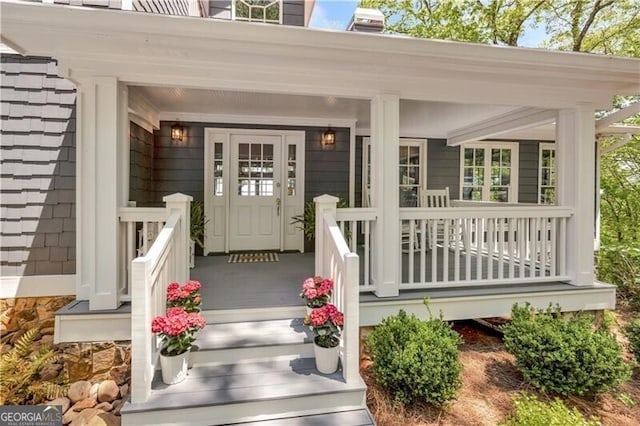 view of exterior entry featuring a porch