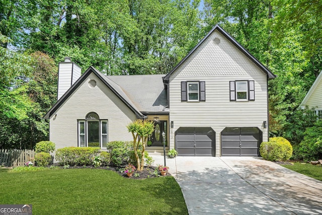 view of front facade featuring driveway, a garage, and a chimney