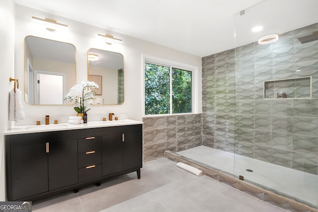 full bathroom featuring tile patterned floors, walk in shower, tile walls, and double vanity