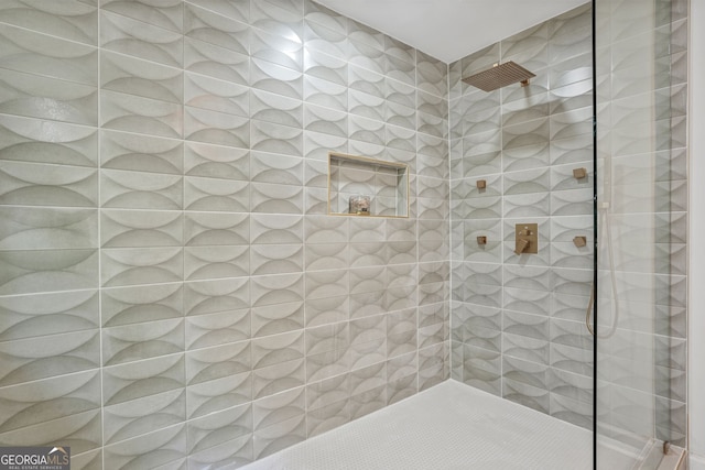 bathroom with a tile shower