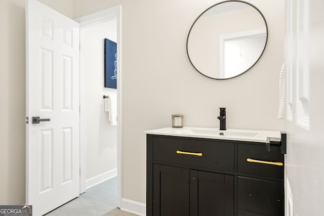 bathroom featuring baseboards and vanity